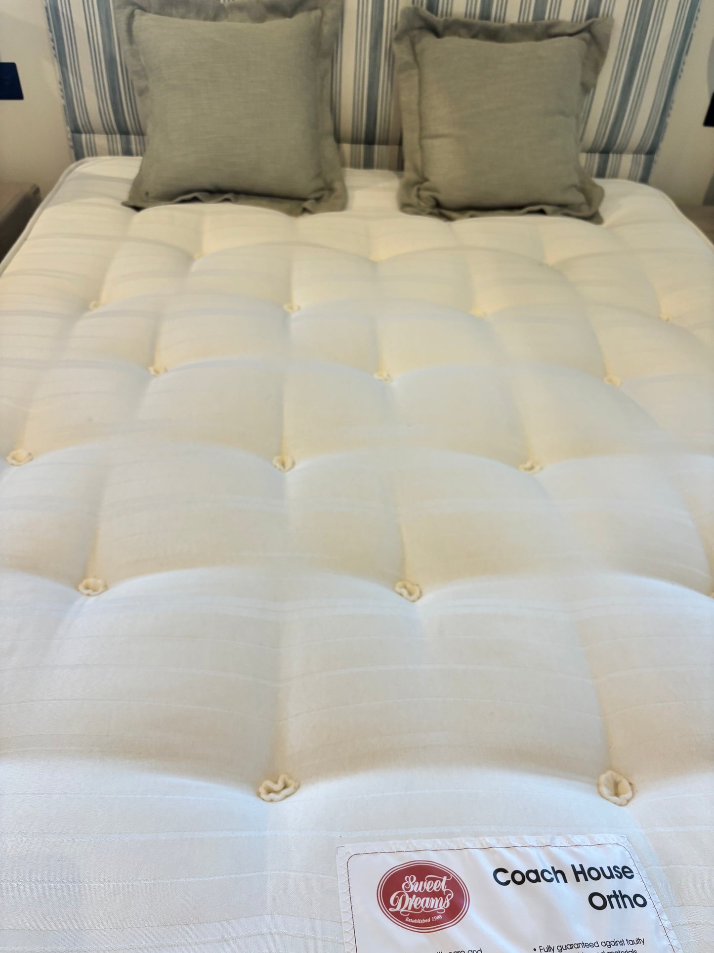 Bespoke Kingsize Bed with Blue and Cream Stripe Upholstered Headboard matching Valence and drawers each side.  Coach House Orthopedic Mattrress